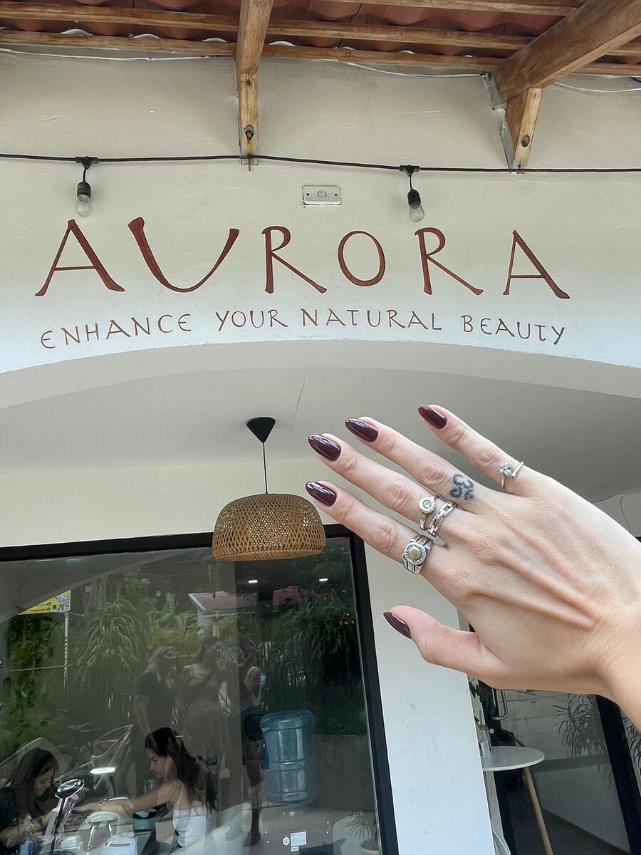 Hand-painted Aurora sign at the salon entrance in Plaza Royal, Santa Teresa